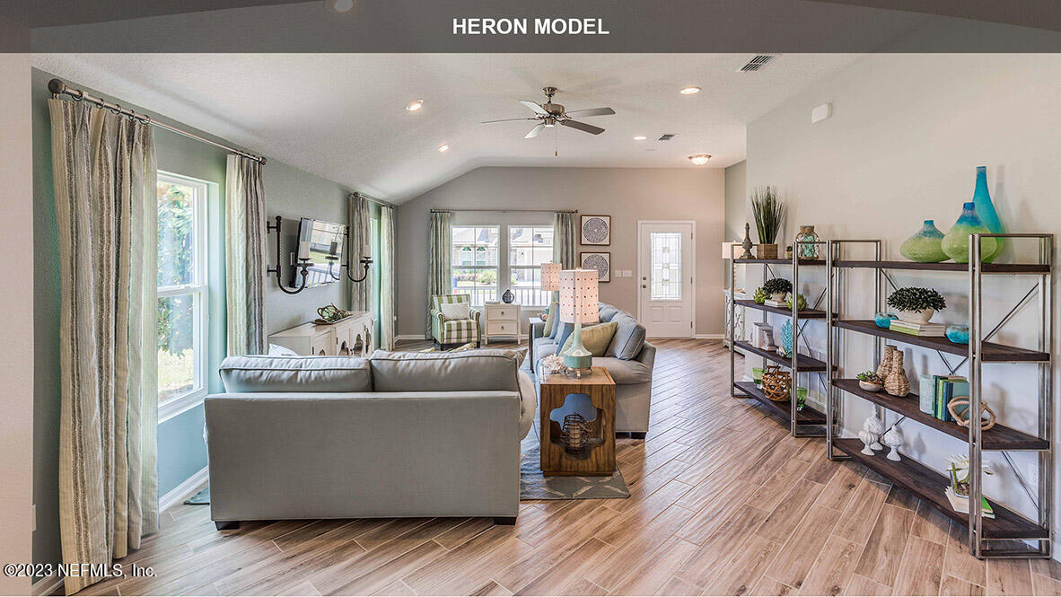 65744 Edgewater Drive Yulee, FL 32097 - Photo 5 of 45 a living room with furniture and a book shelf