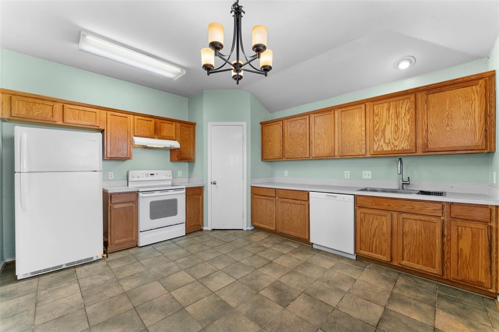 114 Rio Grande Drive Crandall, TX 75114 - Photo 12 of 34 a kitchen with stainless steel appliances granite countertop a sink cabinets and window