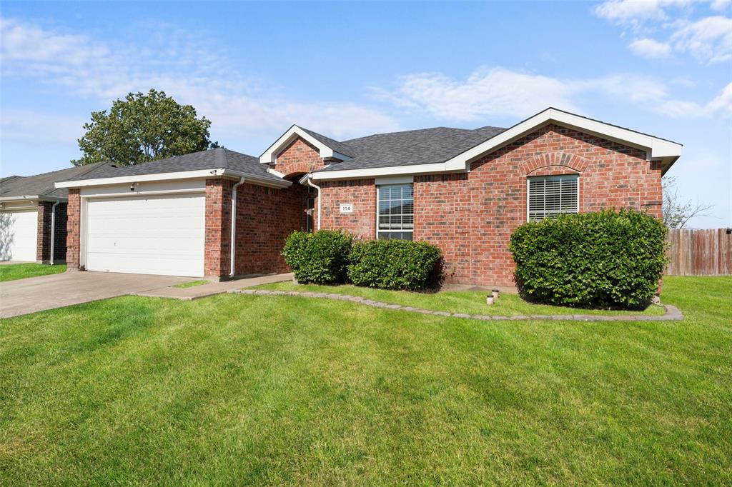 114 Rio Grande Drive Crandall, TX 75114 - Photo 3 of 34 a front view of a house with a yard and garage