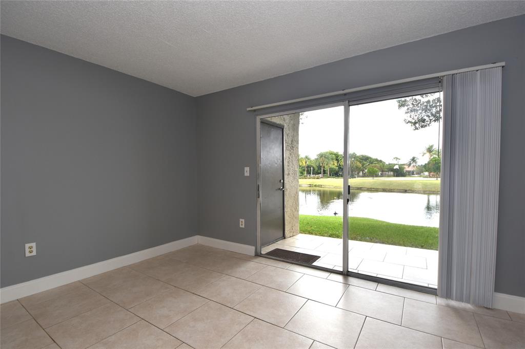 231 Southwest 113th Way, Unit 231 Pembroke Pines, FL 33025 - Photo 11 of 39 a view of an empty room and window