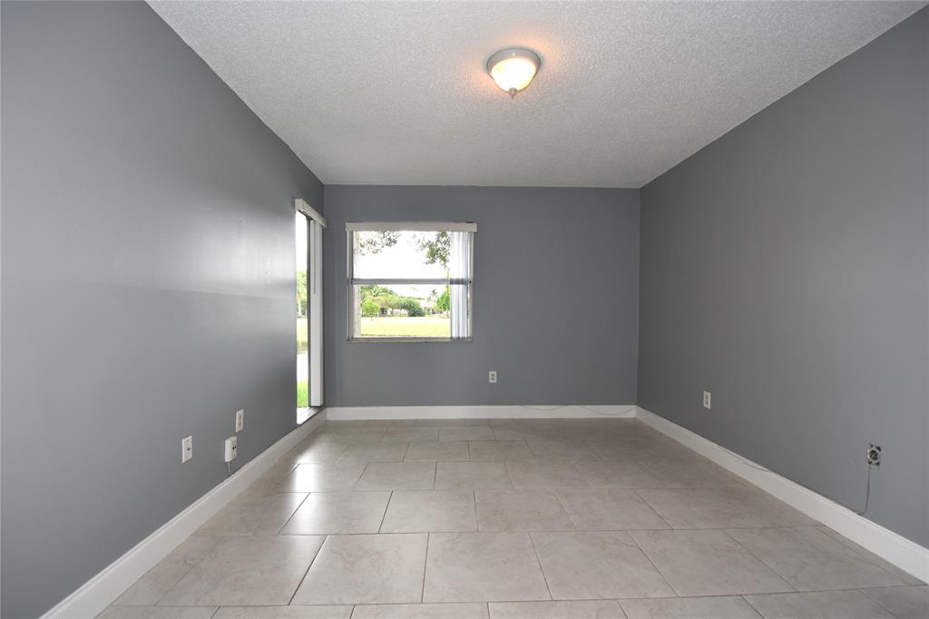 231 Southwest 113th Way, Unit 231 Pembroke Pines, FL 33025 - Photo 12 of 39 an empty room with windows