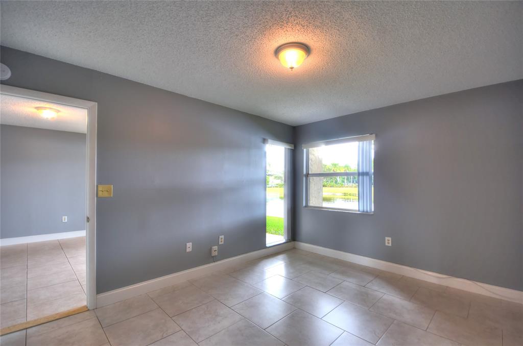 231 Southwest 113th Way, Unit 231 Pembroke Pines, FL 33025 - Photo 13 of 39 a view of an empty room with a window