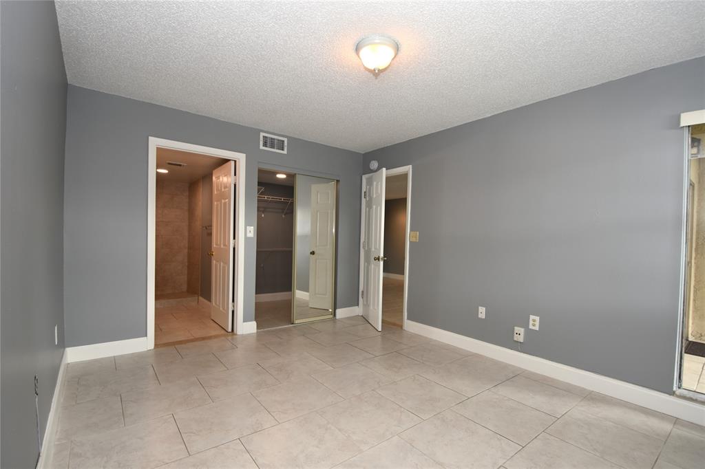 231 Southwest 113th Way, Unit 231 Pembroke Pines, FL 33025 - Photo 14 of 39 an empty room with closet and a chandelier fan