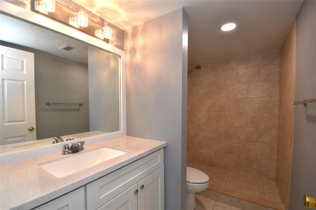 231 Southwest 113th Way, Unit 231 Pembroke Pines, FL 33025 - Photo 17 of 39 a bathroom with a sink a toilet and a mirror