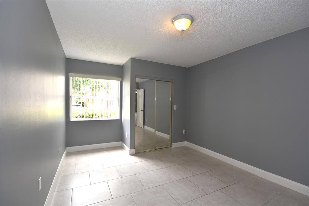 231 Southwest 113th Way, Unit 231 Pembroke Pines, FL 33025 - Photo 21 of 39 a view of an empty room and window
