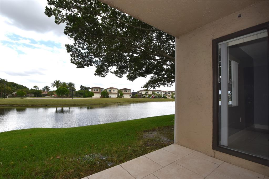 231 Southwest 113th Way, Unit 231 Pembroke Pines, FL 33025 - Photo 30 of 39 a view of a lake with a house in the background