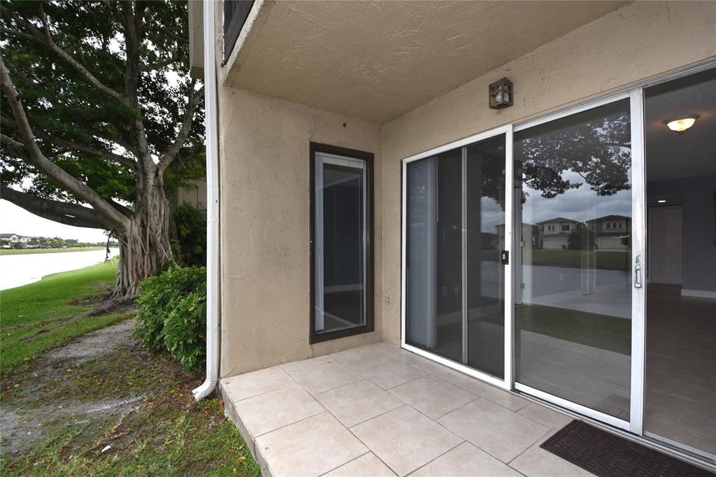 231 Southwest 113th Way, Unit 231 Pembroke Pines, FL 33025 - Photo 32 of 39 a view of a glass door and a yard