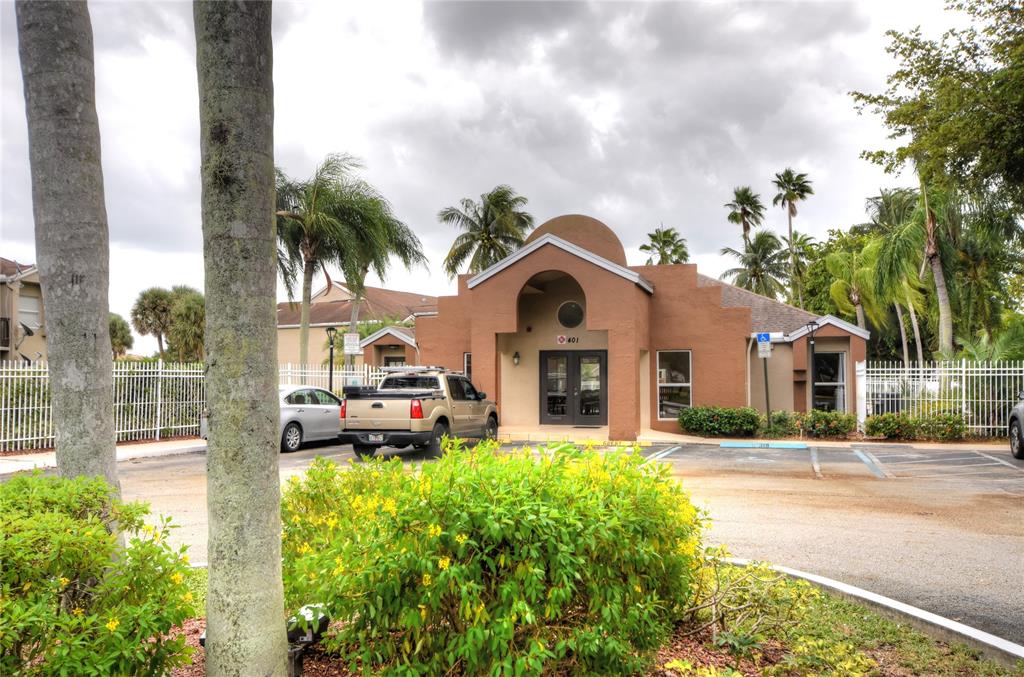 231 Southwest 113th Way, Unit 231 Pembroke Pines, FL 33025 - Photo 33 of 39 a front view of a house with a yard