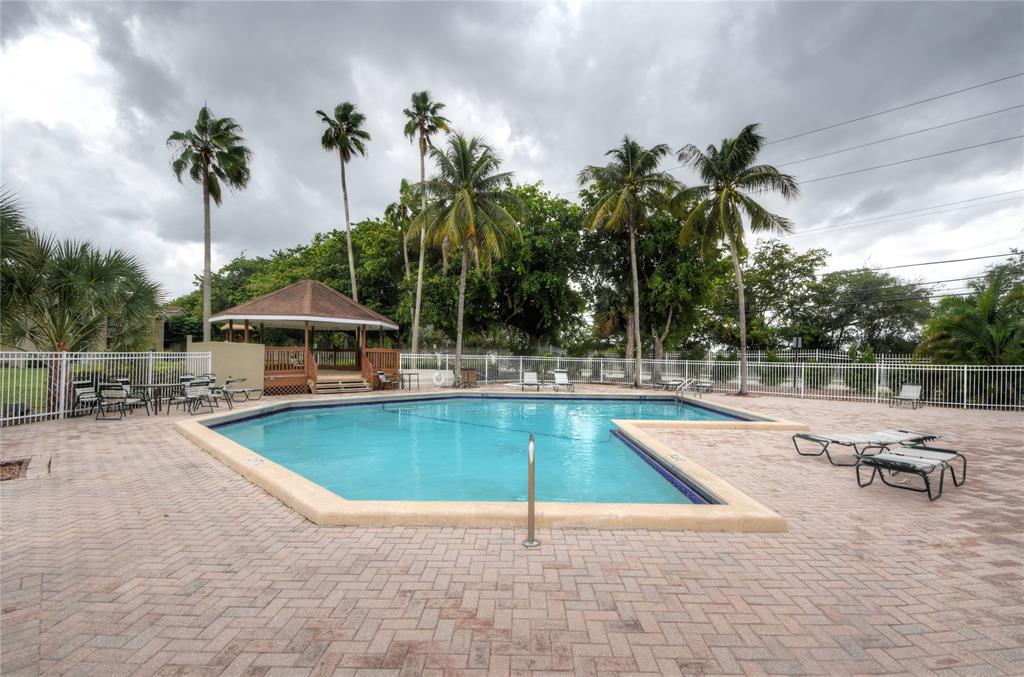 231 Southwest 113th Way, Unit 231 Pembroke Pines, FL 33025 - Photo 37 of 39 a view of a swimming pool with chairs