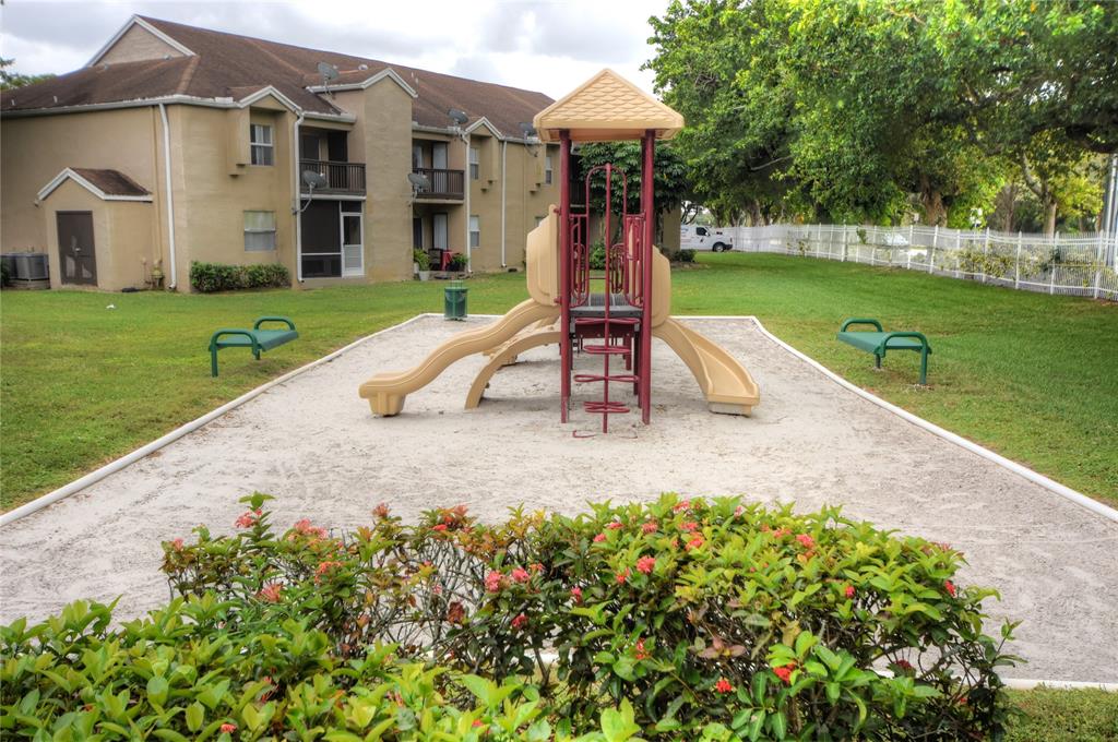 231 Southwest 113th Way, Unit 231 Pembroke Pines, FL 33025 - Photo 38 of 39 a view of a house with a yard patio and slide
