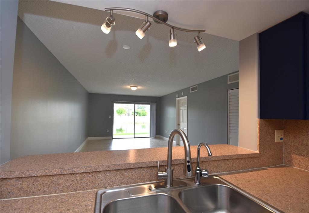 231 Southwest 113th Way, Unit 231 Pembroke Pines, FL 33025 - Photo 39 of 39 a kitchen with a sink and a large window