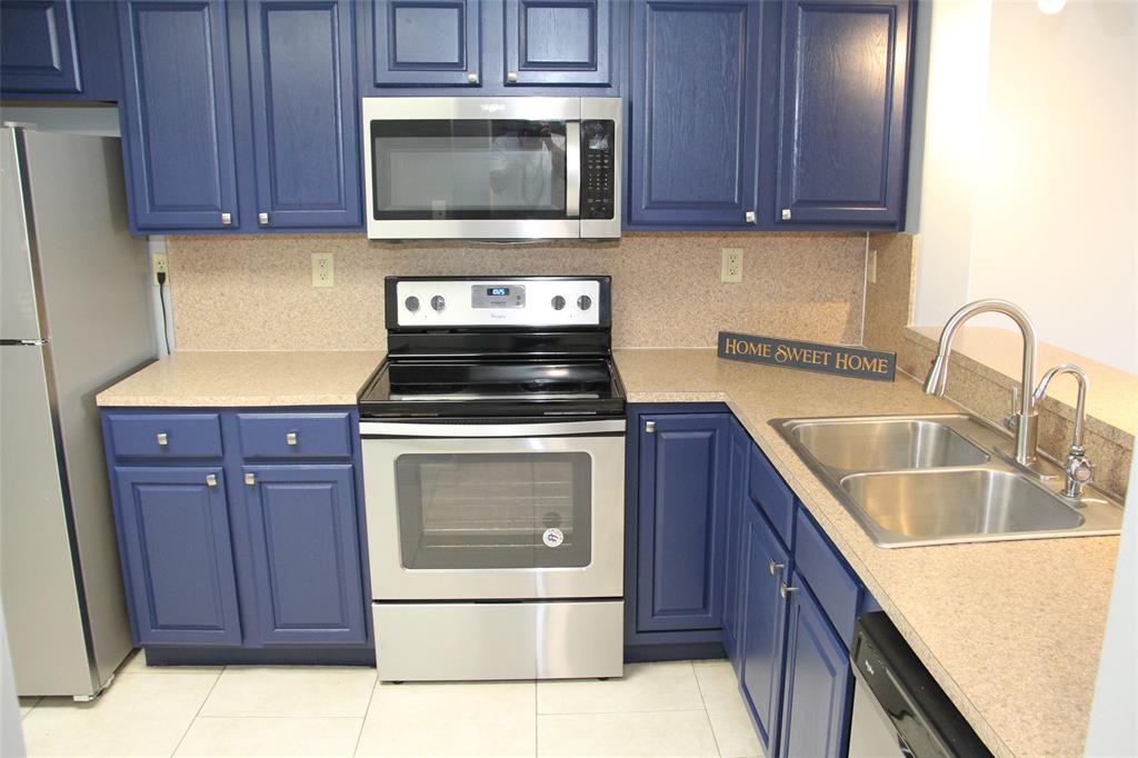 231 Southwest 113th Way, Unit 231 Pembroke Pines, FL 33025 - Photo 6 of 39 a kitchen with a stove microwave and sink