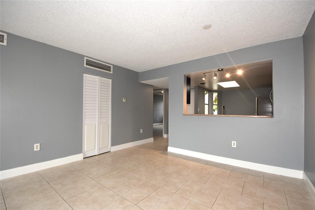 231 Southwest 113th Way, Unit 231 Pembroke Pines, FL 33025 - Photo 10 of 39 a view of an empty room with window and bathroom