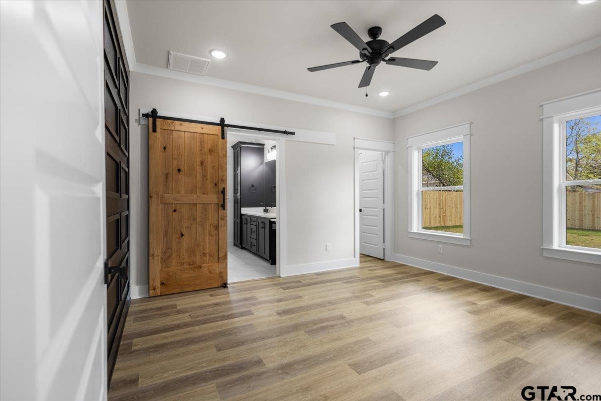 3022 West Rose Street Tyler, TX 75701 - Photo 19 of 46 a view of a livingroom with a ceiling fan & a window
