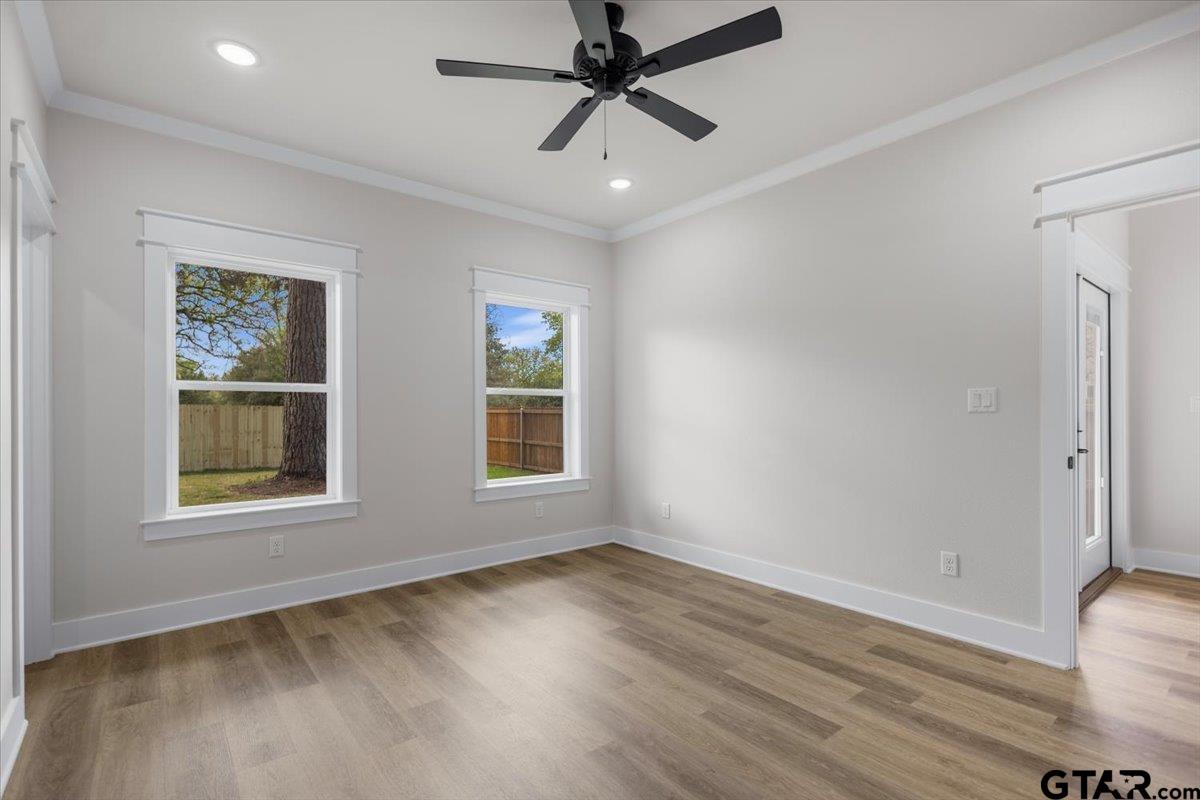 3022 West Rose Street Tyler, TX 75701 - Photo 20 of 46 a view of an empty room with a window and wooden floor