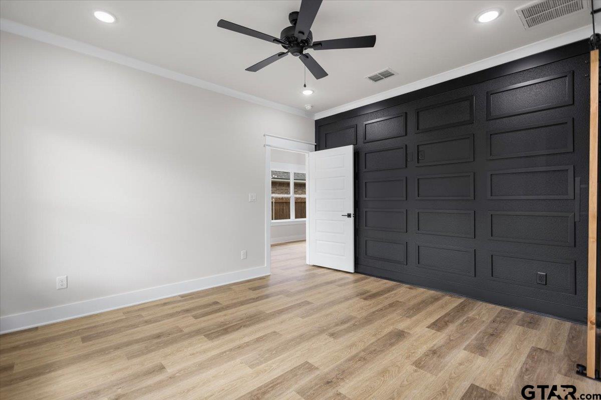 3022 West Rose Street Tyler, TX 75701 - Photo 21 of 46 a view of a livingroom with closet and a ceiling fan