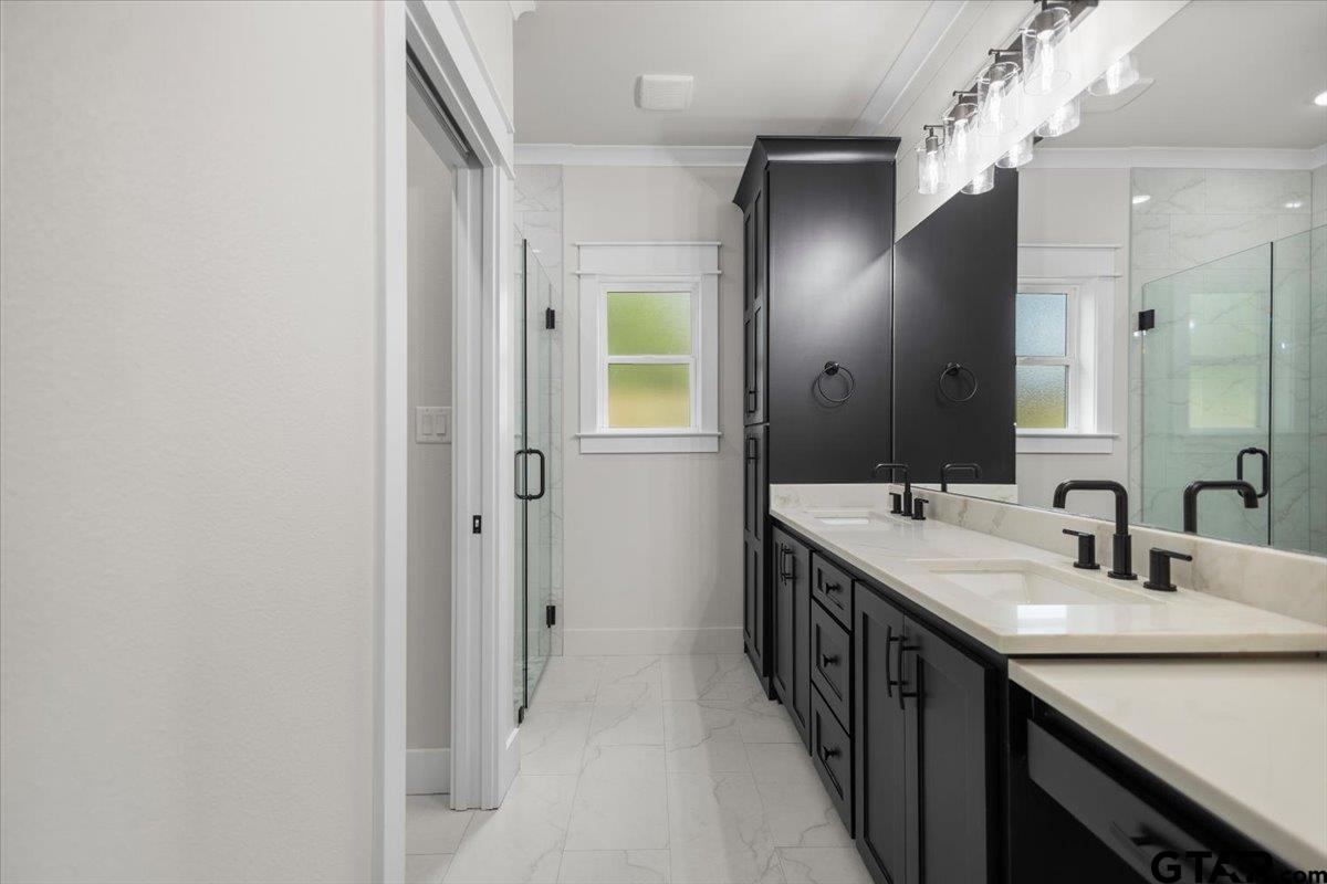 3022 West Rose Street Tyler, TX 75701 - Photo 24 of 46 a bathroom with a double vanity sink and a mirror