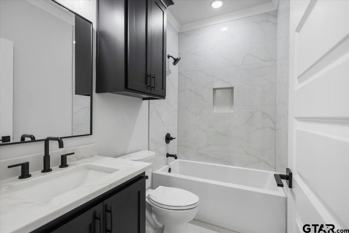 3022 West Rose Street Tyler, TX 75701 - Photo 30 of 46 a bathroom with a granite countertop sink toilet and shower