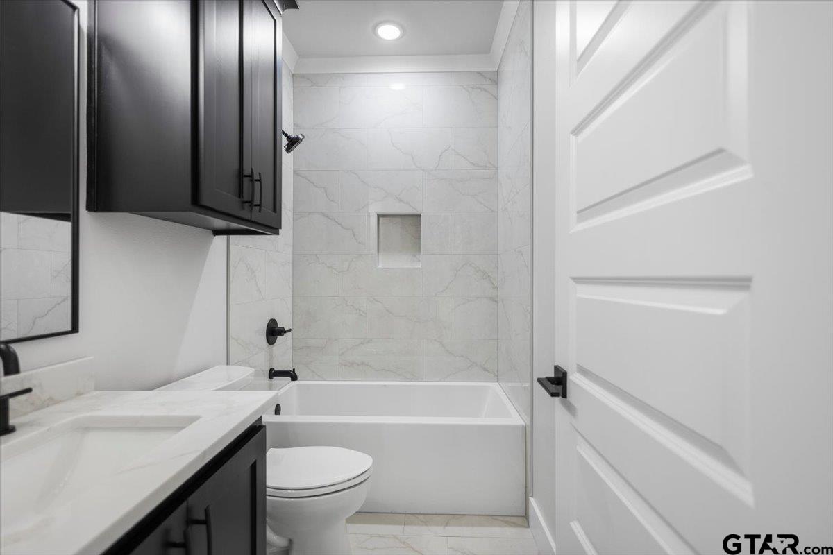 3022 West Rose Street Tyler, TX 75701 - Photo 31 of 46 a bathroom with a granite countertop sink toilet and shower