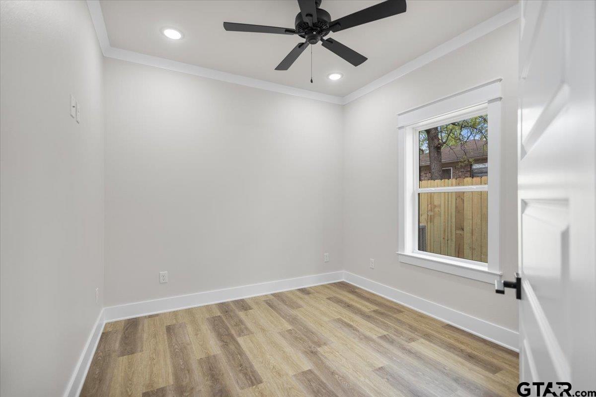 3022 West Rose Street Tyler, TX 75701 - Photo 32 of 46 an empty room with a window and a chandelier fan