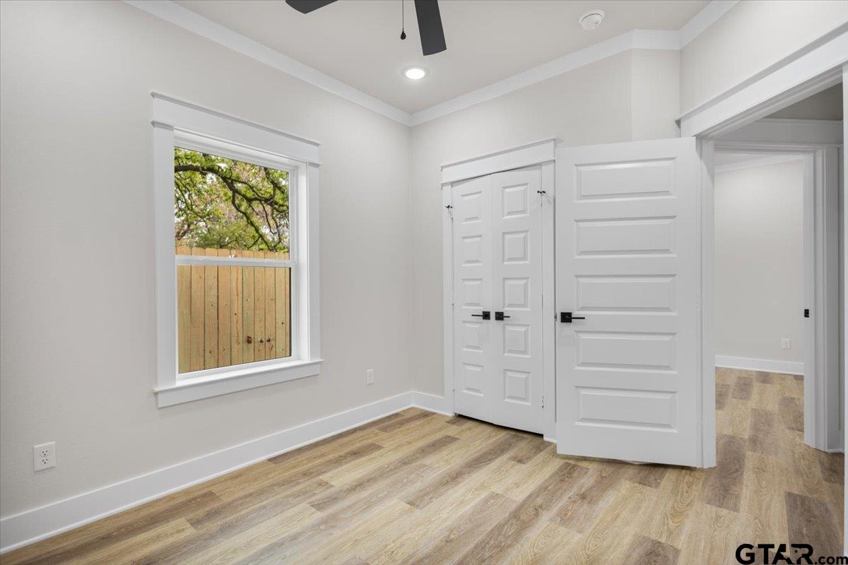3022 West Rose Street Tyler, TX 75701 - Photo 33 of 46 an empty room with wooden floor closet and windows