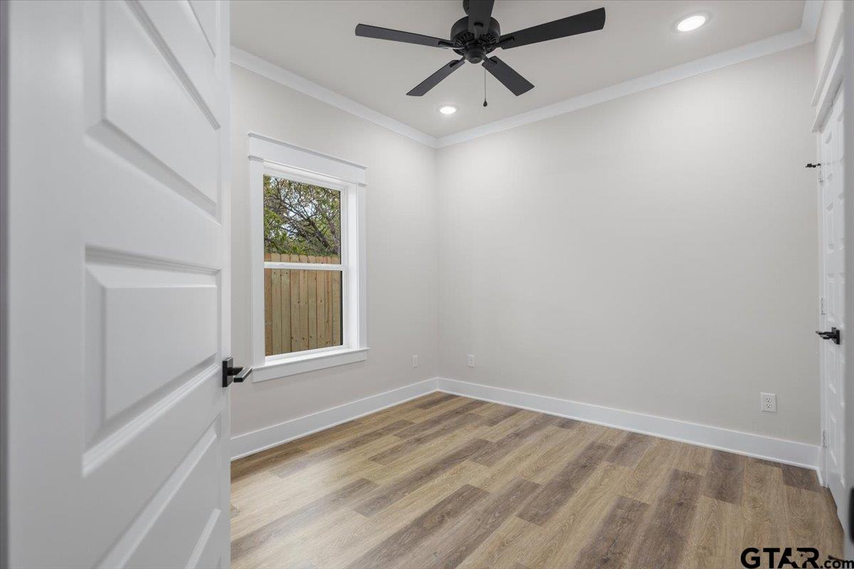 3022 West Rose Street Tyler, TX 75701 - Photo 36 of 46 an empty room with a window and a ceiling fan