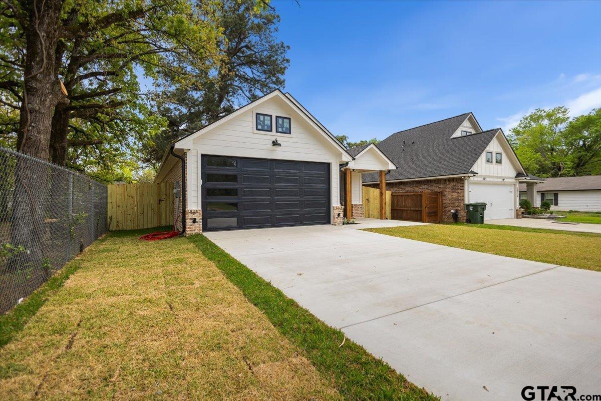 3022 West Rose Street Tyler, TX 75701 - Photo 4 of 46 a front view of a house with a yard and garage
