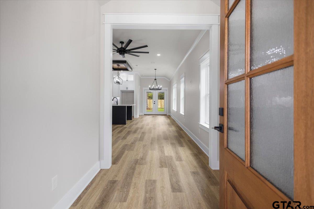 3022 West Rose Street Tyler, TX 75701 - Photo 7 of 46 a view of a hallway with wooden floor and staircase