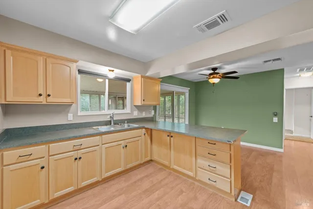 a spacious bathroom with a granite countertop sink mirror and cabinets