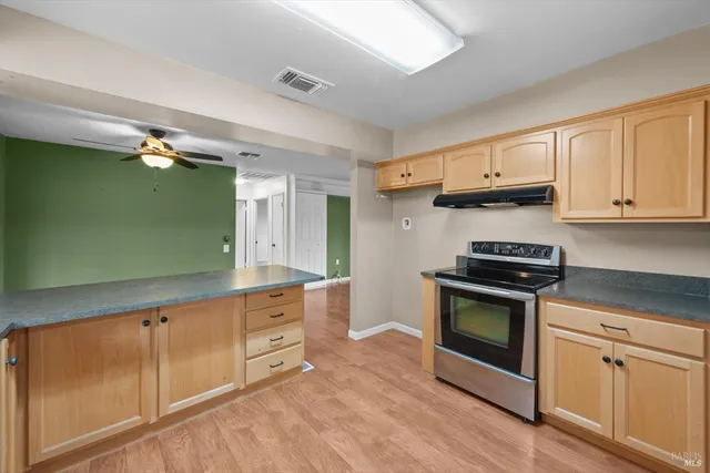 a kitchen with granite countertop a stove and a sink