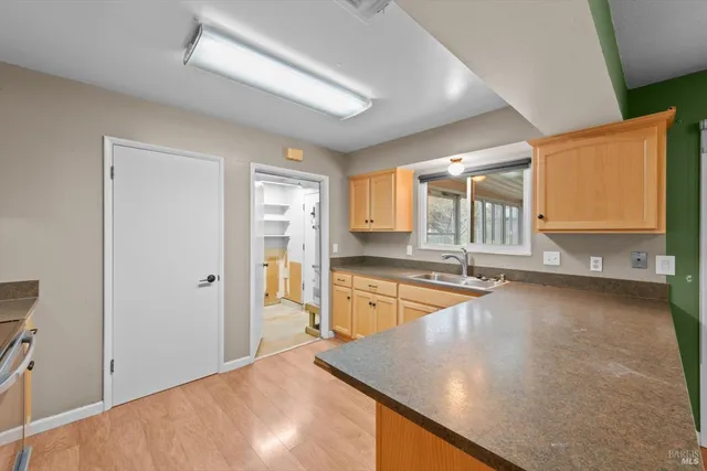 a large kitchen with granite countertop a sink and dishwasher with a large window