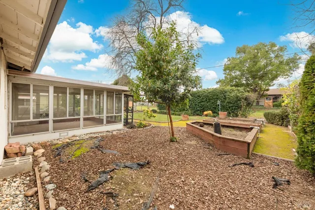 a view of a house with a backyard
