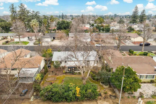 an aerial view of a house with a yard and plants