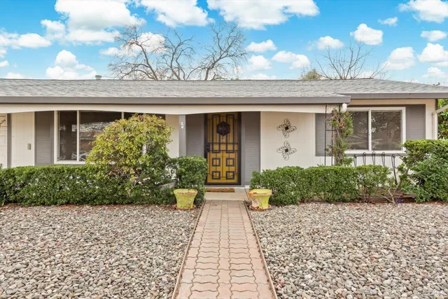 a front view of a house with garden