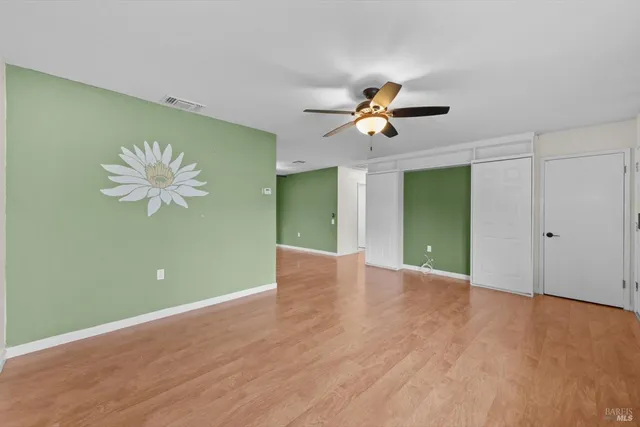a view of a room with a fan and a fan