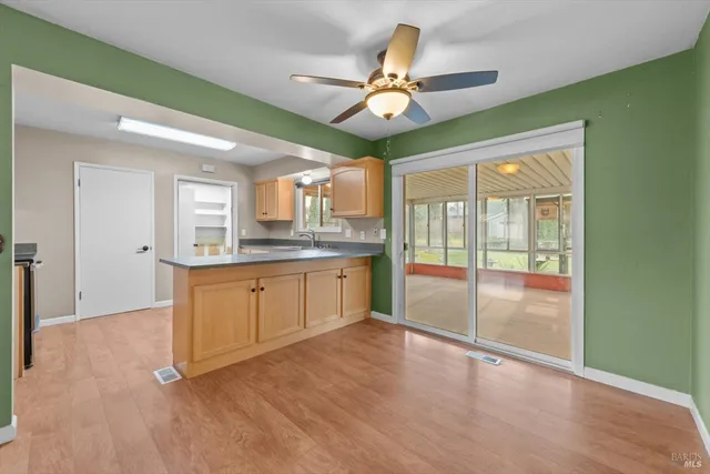 a view of a kitchen with a sink and a window
