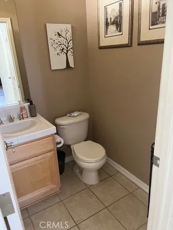 a white toilet sitting next to a bathroom sink