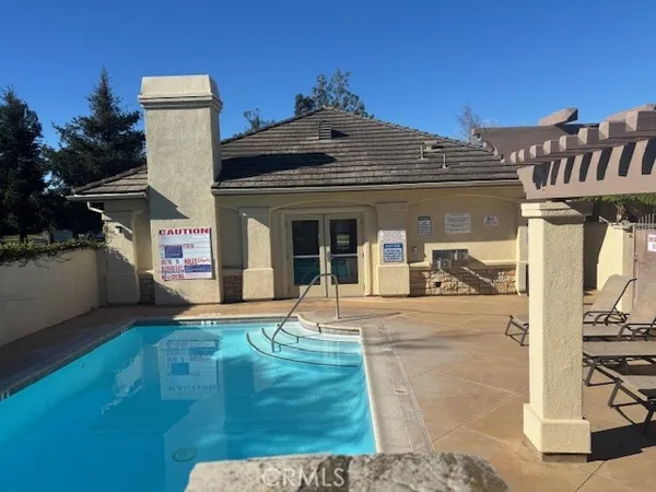 a living room with furniture a dining table and a chandelier