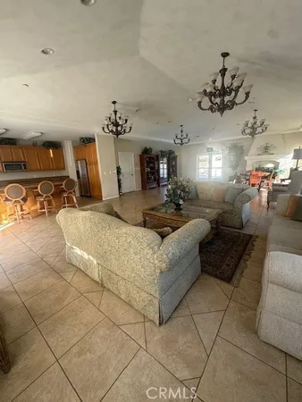 a living room with furniture and chandelier