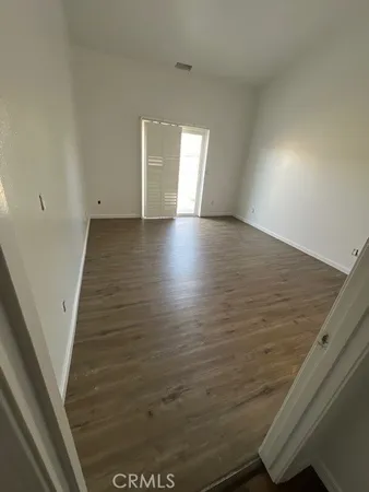 a view of wooden floor and windows in a room