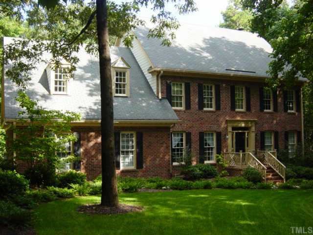 a front view of a house with a yard and porch