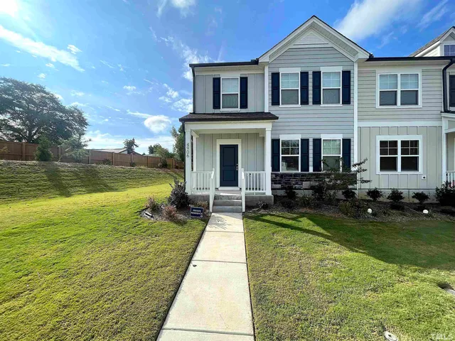 a view of swimming pool with lawn chairs and a yard