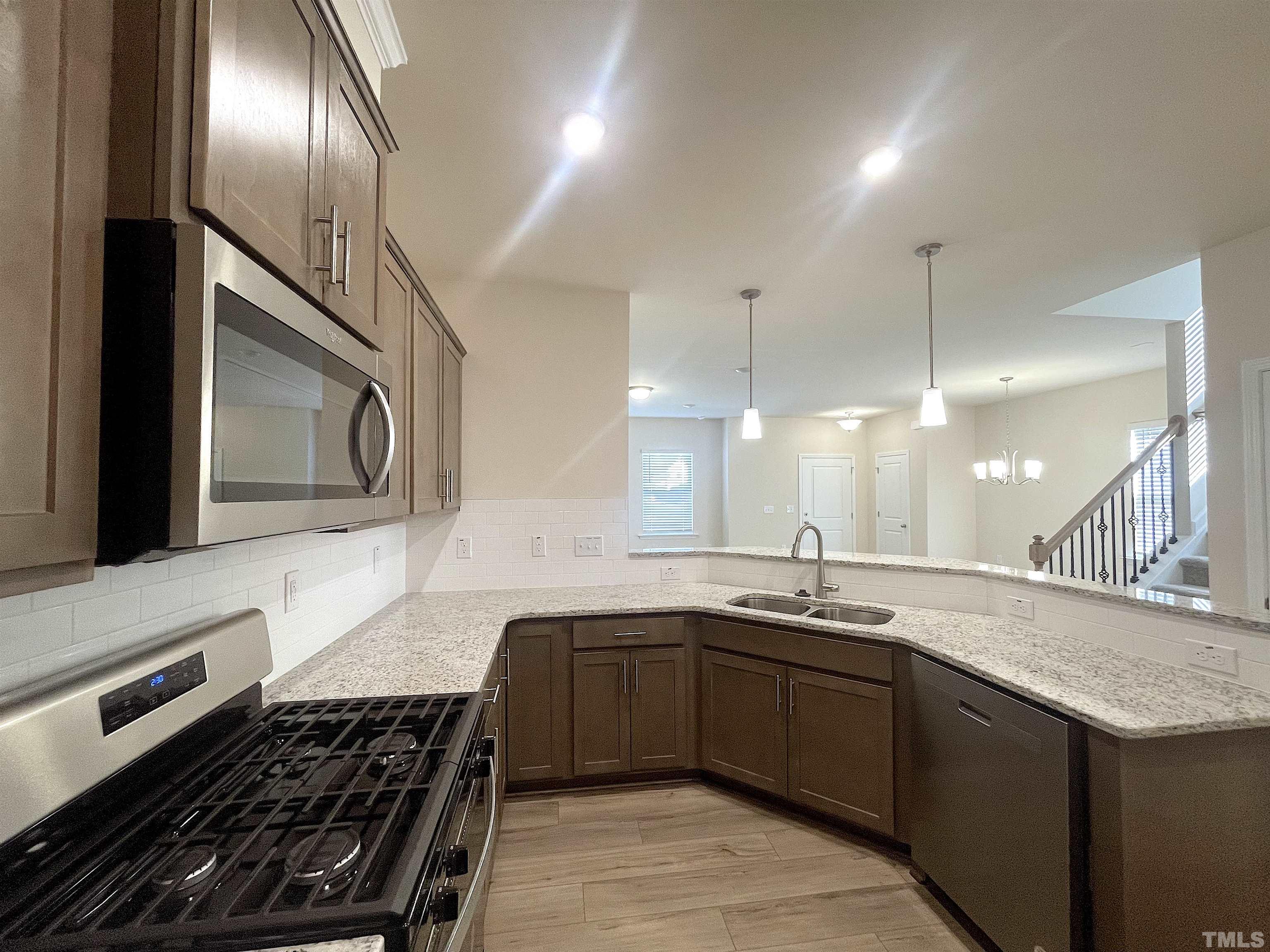4906 Megara Run Raleigh, NC 27603 - Photo 11 of 30 a kitchen with a sink and stove