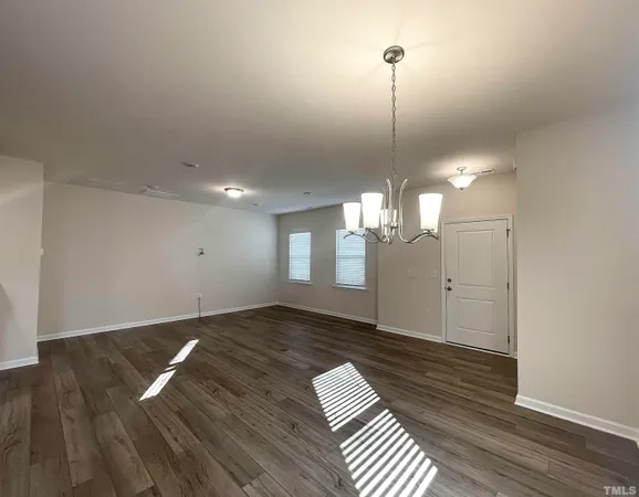 a view of a room with wooden floor and windows