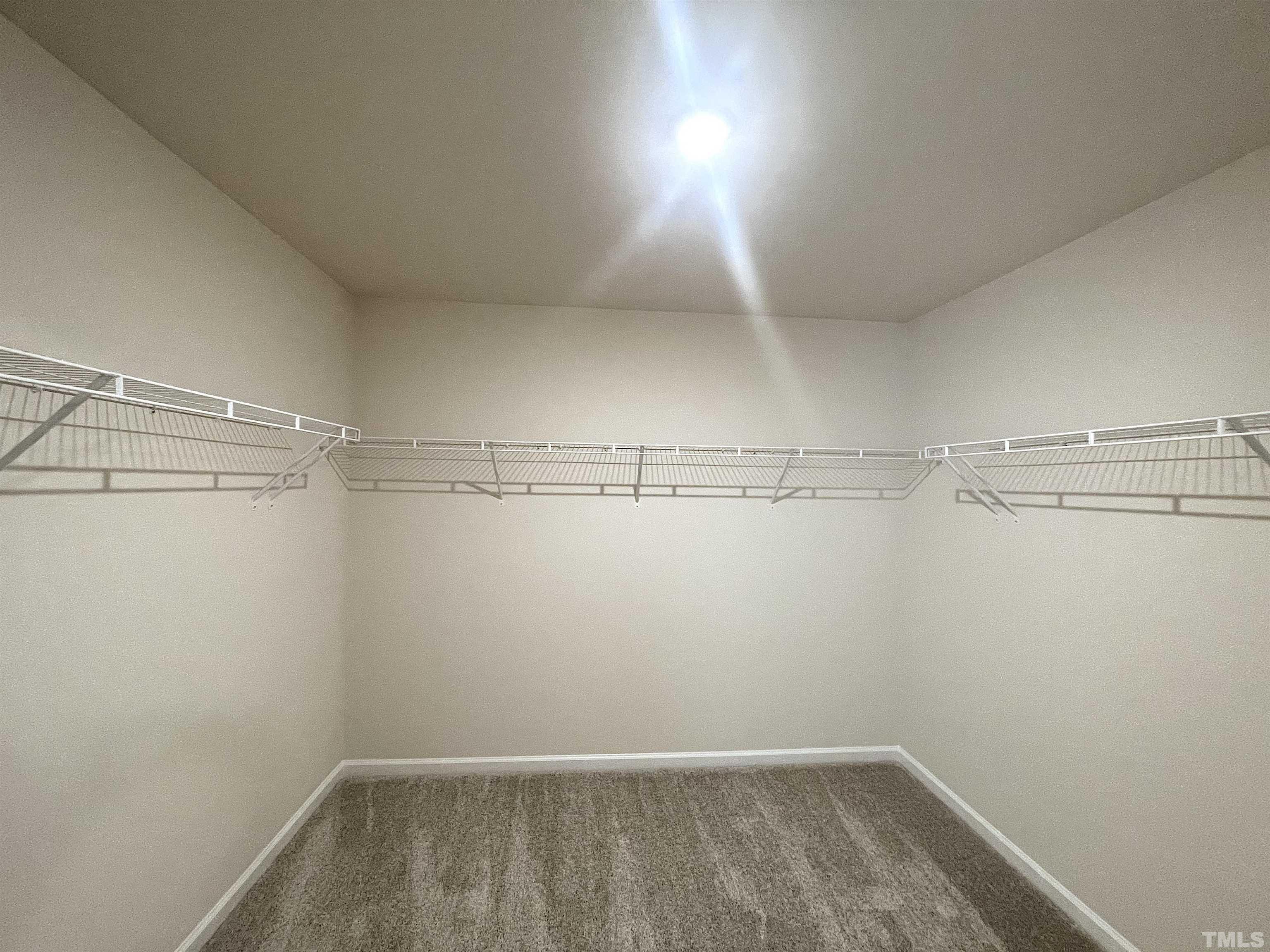 4906 Megara Run Raleigh, NC 27603 - Photo 28 of 30 a view of a room with racks on the wall