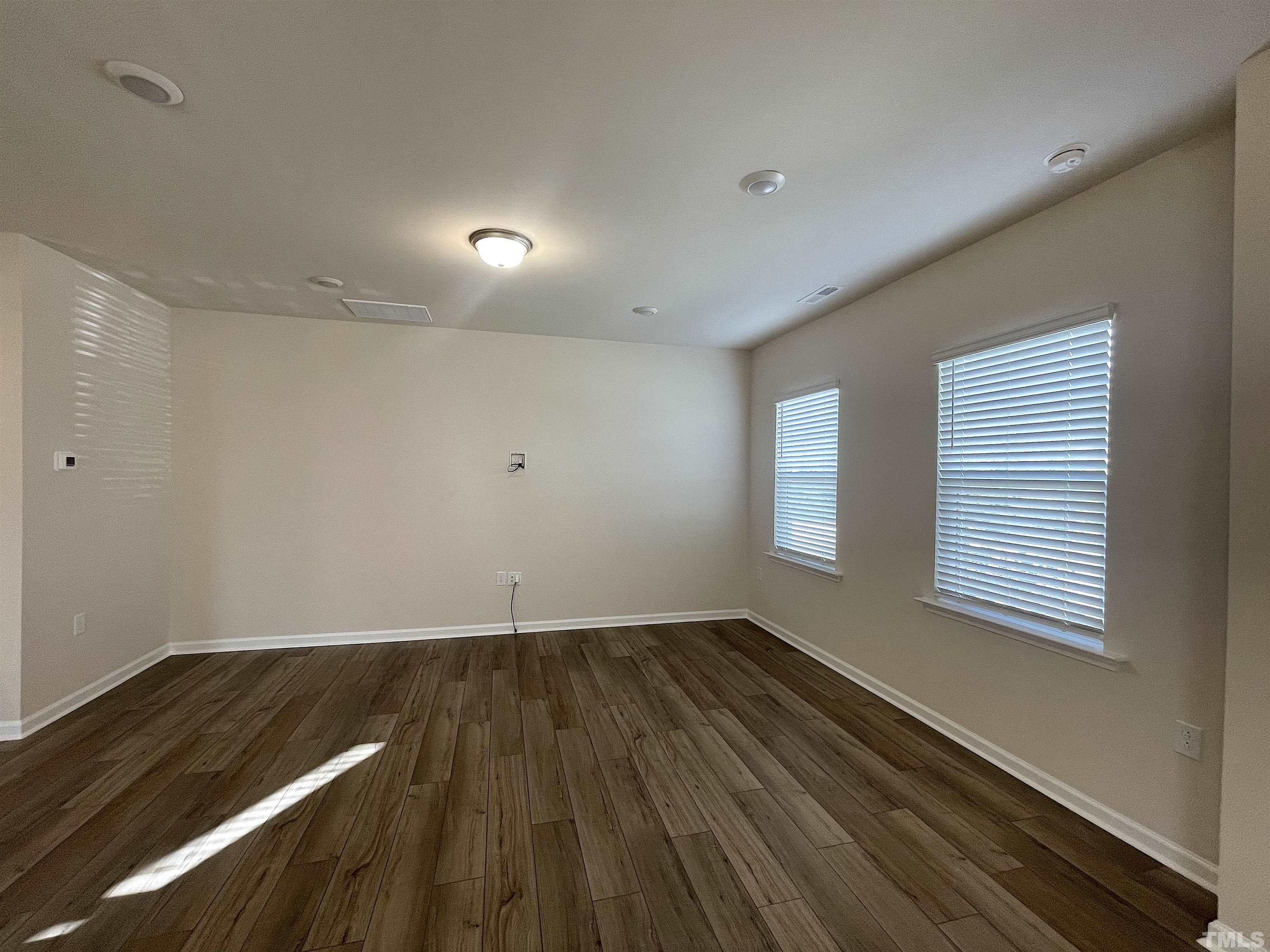 4906 Megara Run Raleigh, NC 27603 - Photo 3 of 30 a view of an empty room with wooden floor and a window