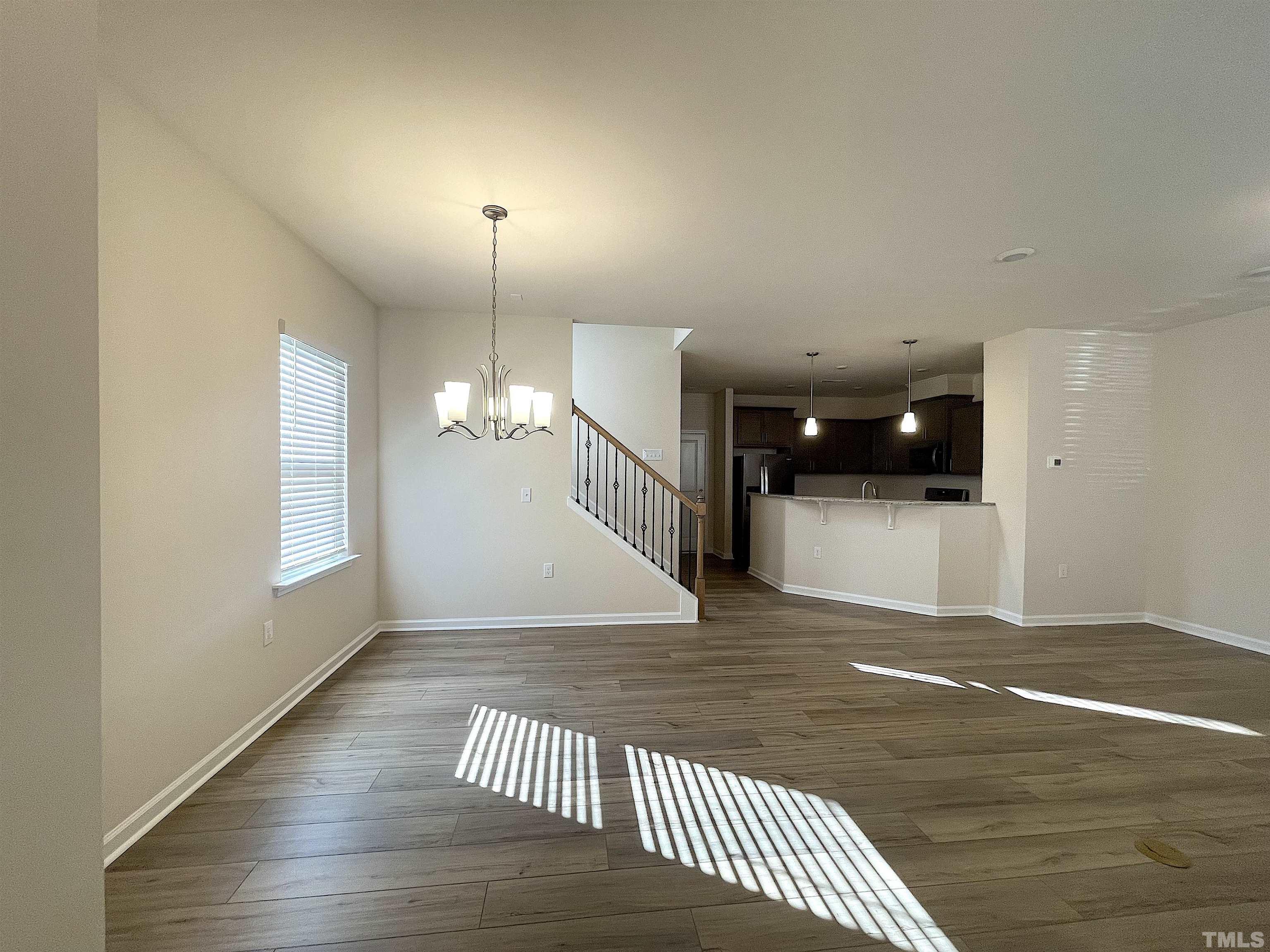 4906 Megara Run Raleigh, NC 27603 - Photo 4 of 30 an empty room with wooden floor and windows