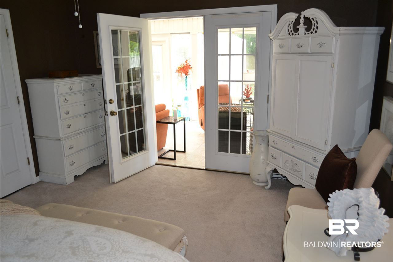 8723 Patterson Path Lillian, AL 36549 - Photo 16 of 46 The Master Bedroom opens to the sun porch