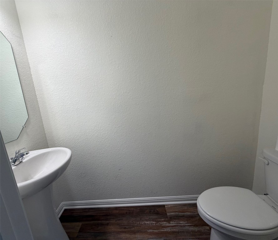 364 Bell Rings Drive Jarrell, TX 76537 - Photo 10 of 25 Bathroom with baseboards and dark wood-style flooring