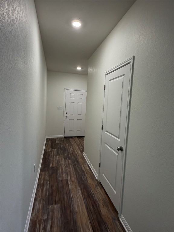 364 Bell Rings Drive Jarrell, TX 76537 - Photo 11 of 25 Corridor featuring dark wood-style flooring, a textured wall, and recessed lighting